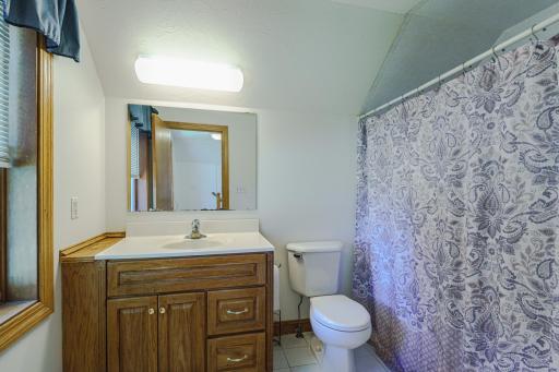 This FULL bathroom lies near the bedrooms.