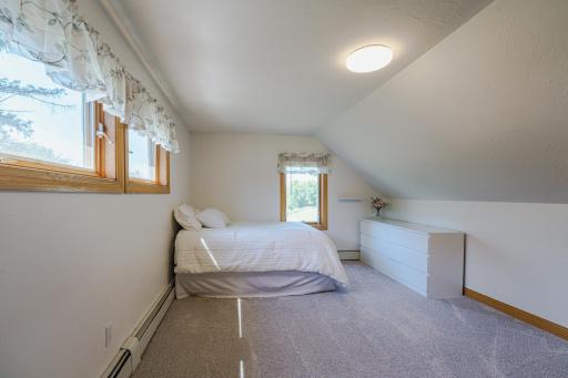 This is one of two upper level bedrooms. This room has operable windows on two sides of the room.