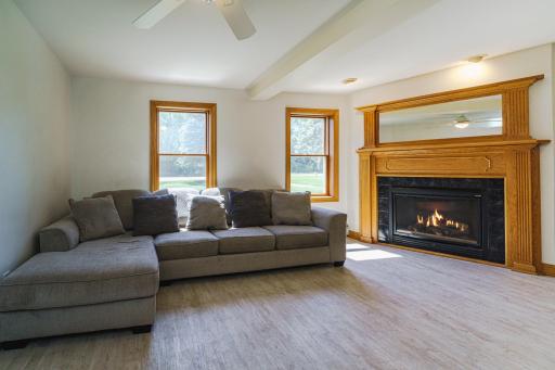 The main floor family room has a gas fireplace. Windows overlook the front of the home.