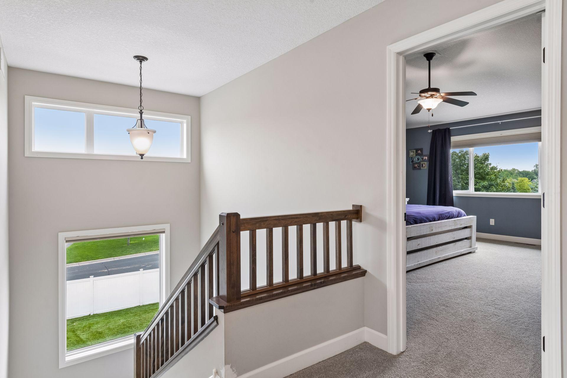 Bright open staircase with wall of windows.