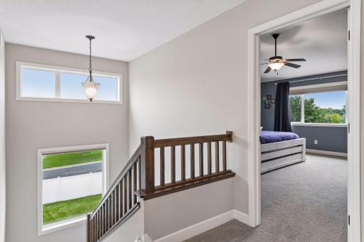 Bright open staircase with wall of windows.