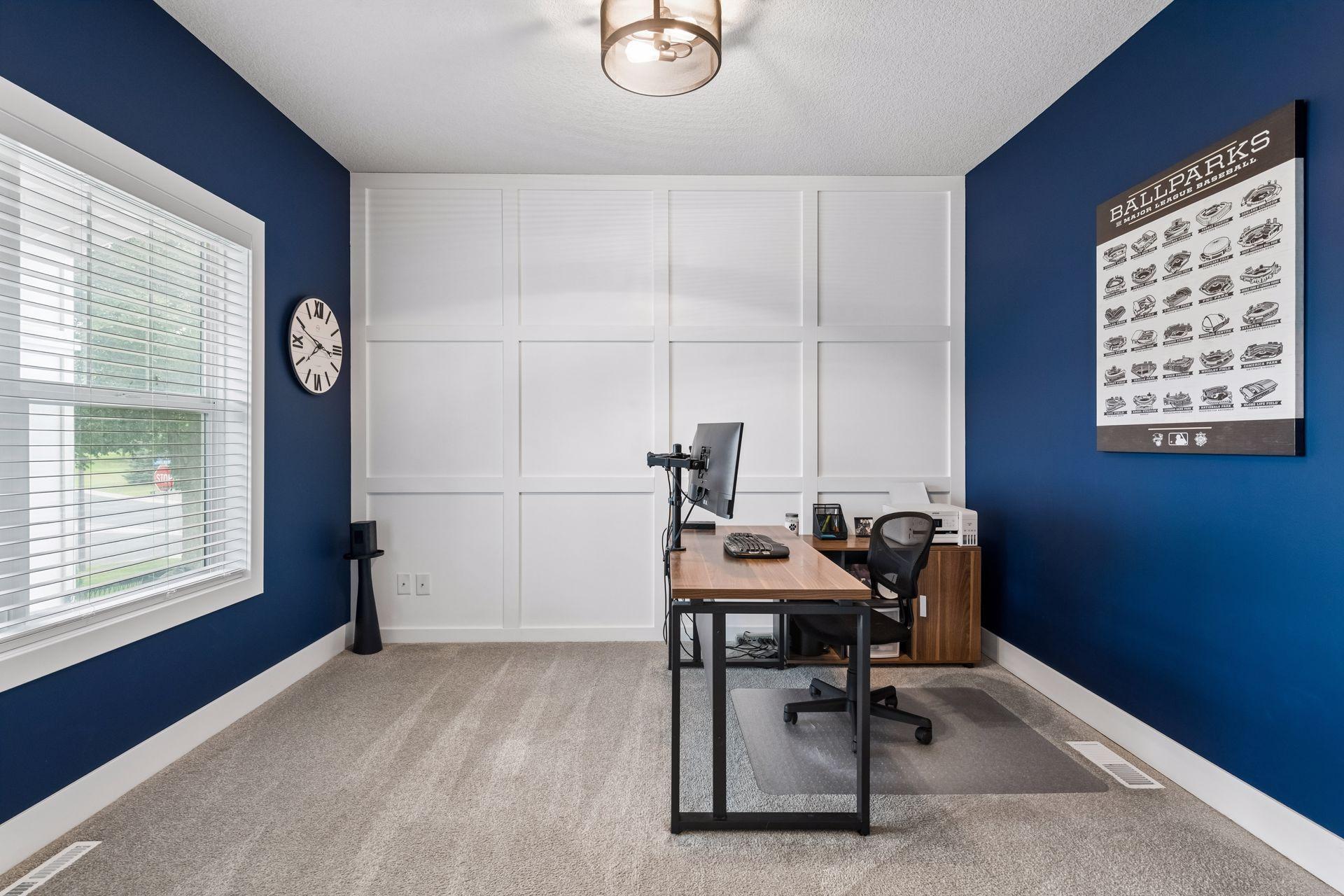 Main level office with french doors and custom accent wall.