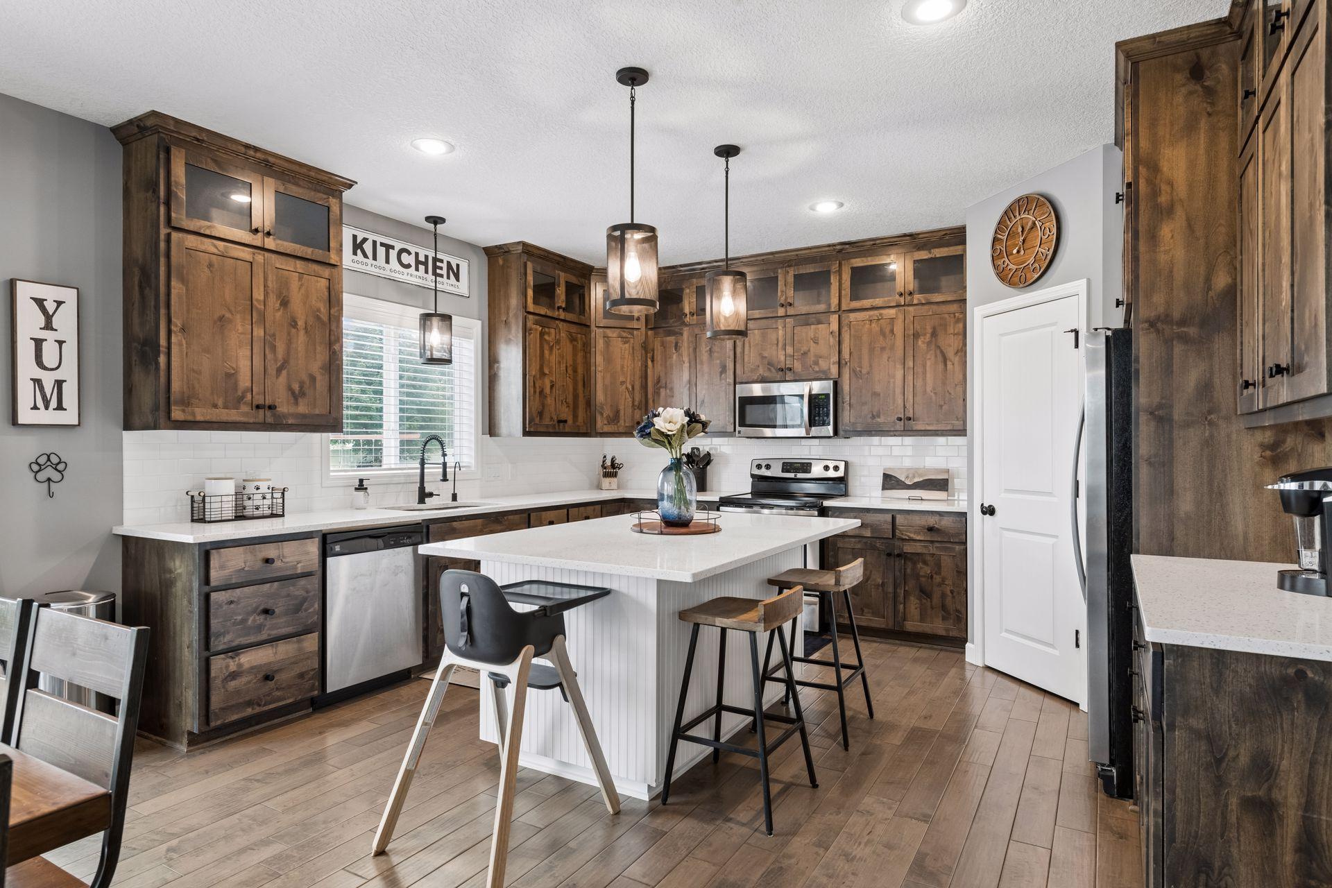 Custom kitchen features gorgeous custom cabinets, large island, walk-in pantry and coffee bar!
