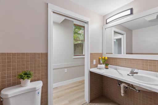 This fully accessible 3/4 bath has fresh counters & brand new lighting, too!
