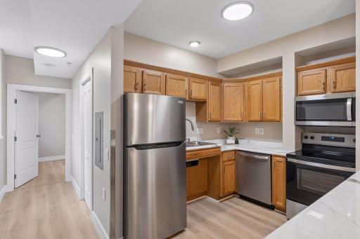 Enjoy brand new SS kitchen appliances + designed with accessibility in mind allowing for a wheelchair to roll under the kitchen counter & sink area.