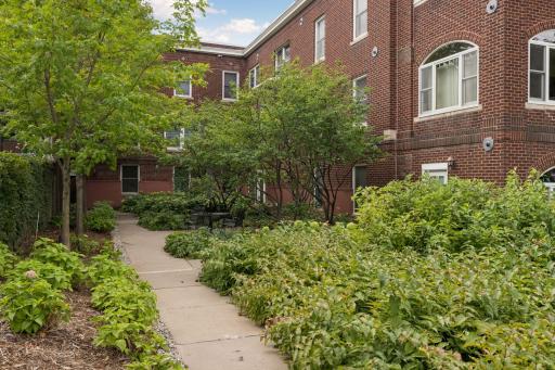 Lovely walk-way & shared patio outside of this first floor unit.