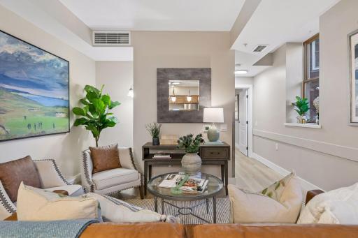 9' ceilings throughout & living room shown with access to the primary bedroom down the hall.