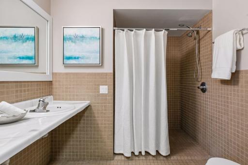 3/4 bath with updated counter & zero entry shower. This is located just outside of the primary BR.