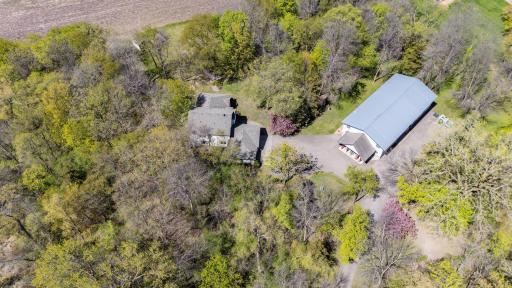This is an aerial view of the house and the garage Mahal. Notice how much asphalt there is. Not only is the entire driveway asphalt from the road you have a lot of parking spaces to the side of the shed as well