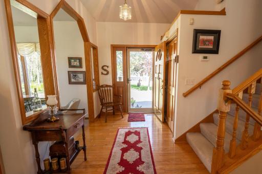 Large open foyer to the right is a coat closet, to the left is the front formal living room period notice the beautiful hardwood floors