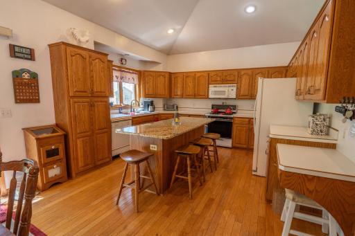 Spacious custom cabinets, center island, hardwood floors and lots of storage in cooking space. Centre island has electricity, all appliances stay with the home