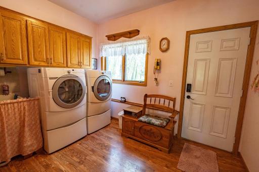 Main level laundry room has its own entrance to the exterior of the home and to the right that's not in the photo is the door to the attached garage. Laundry room includes appliances and sink