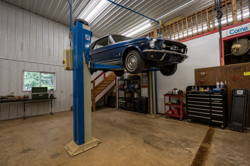 The shop has endless possibilities, and the car lift and air compressor stay with the purchase of the home. If you like to work on cars, the lift is already installed. Virtually staged.