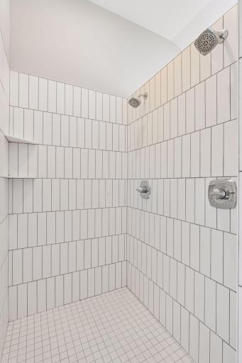 Elegantly tiled walk-in shower in master bath.