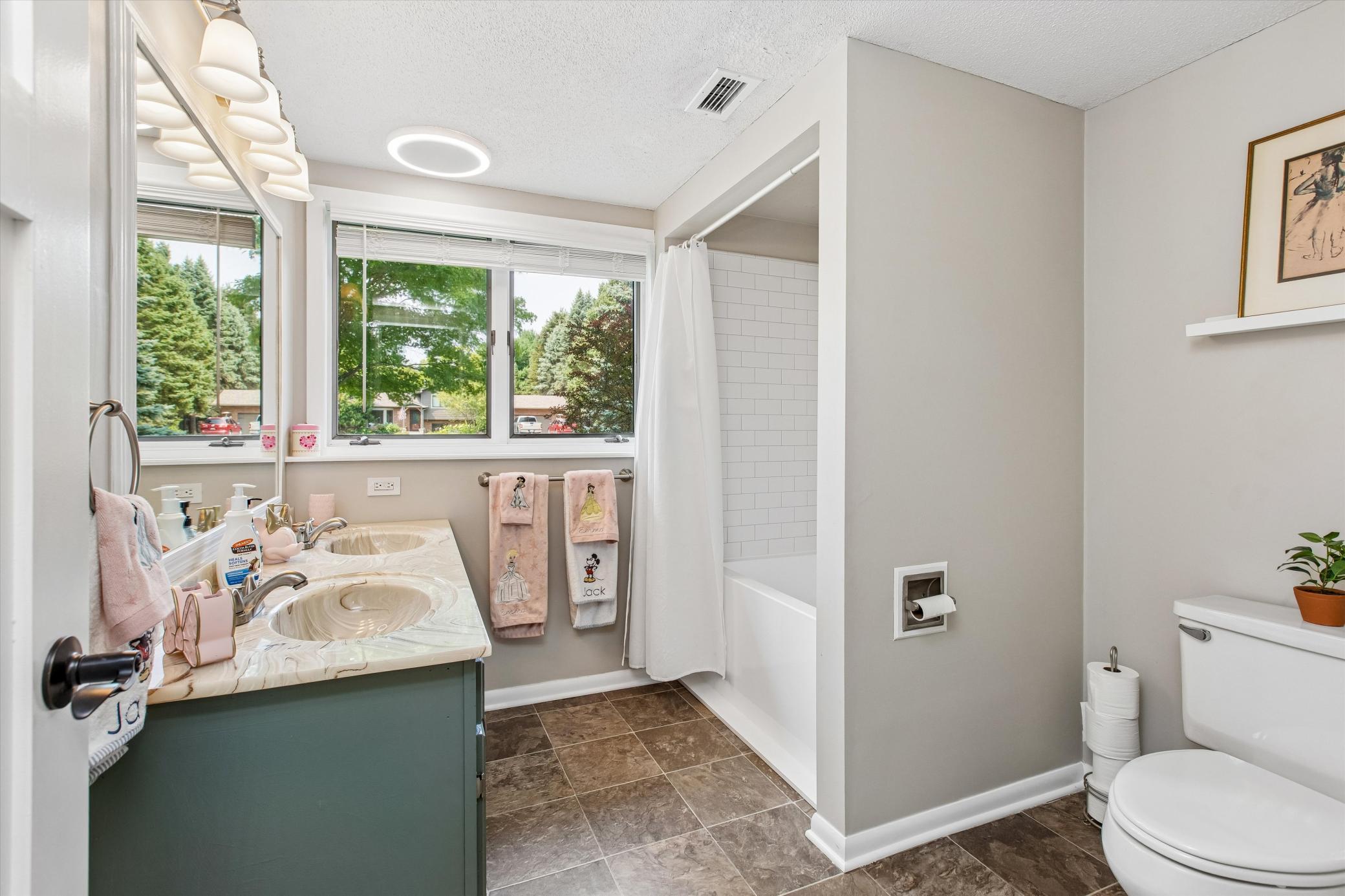 LL bathroom with tub and double sink vanity.