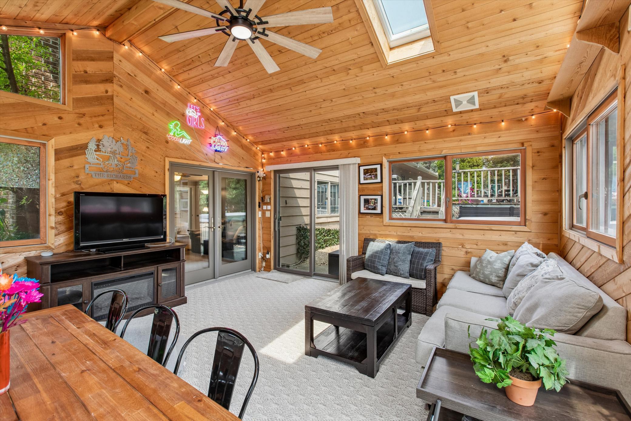 sunroom with another patio door to the hot tub area.