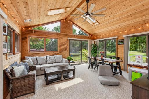Sunroom with vaulted ceiling, 2 patio doors to the backyard.