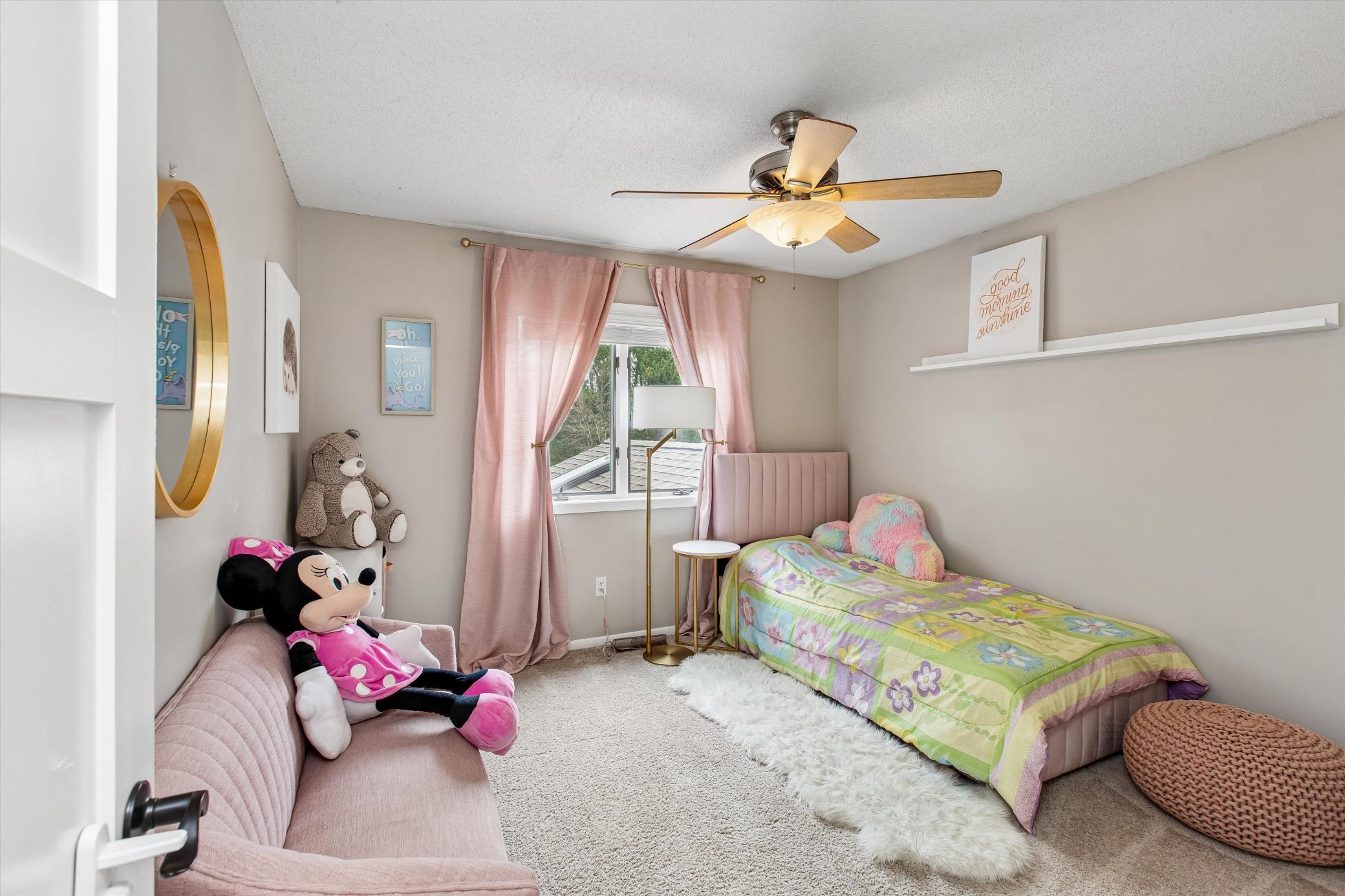 bedroom 2 on the upper level. ceiling fan and large closet