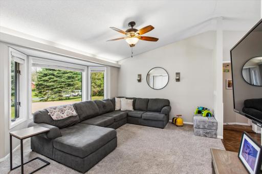 Living room with bay window, vaulted, ceiling fan