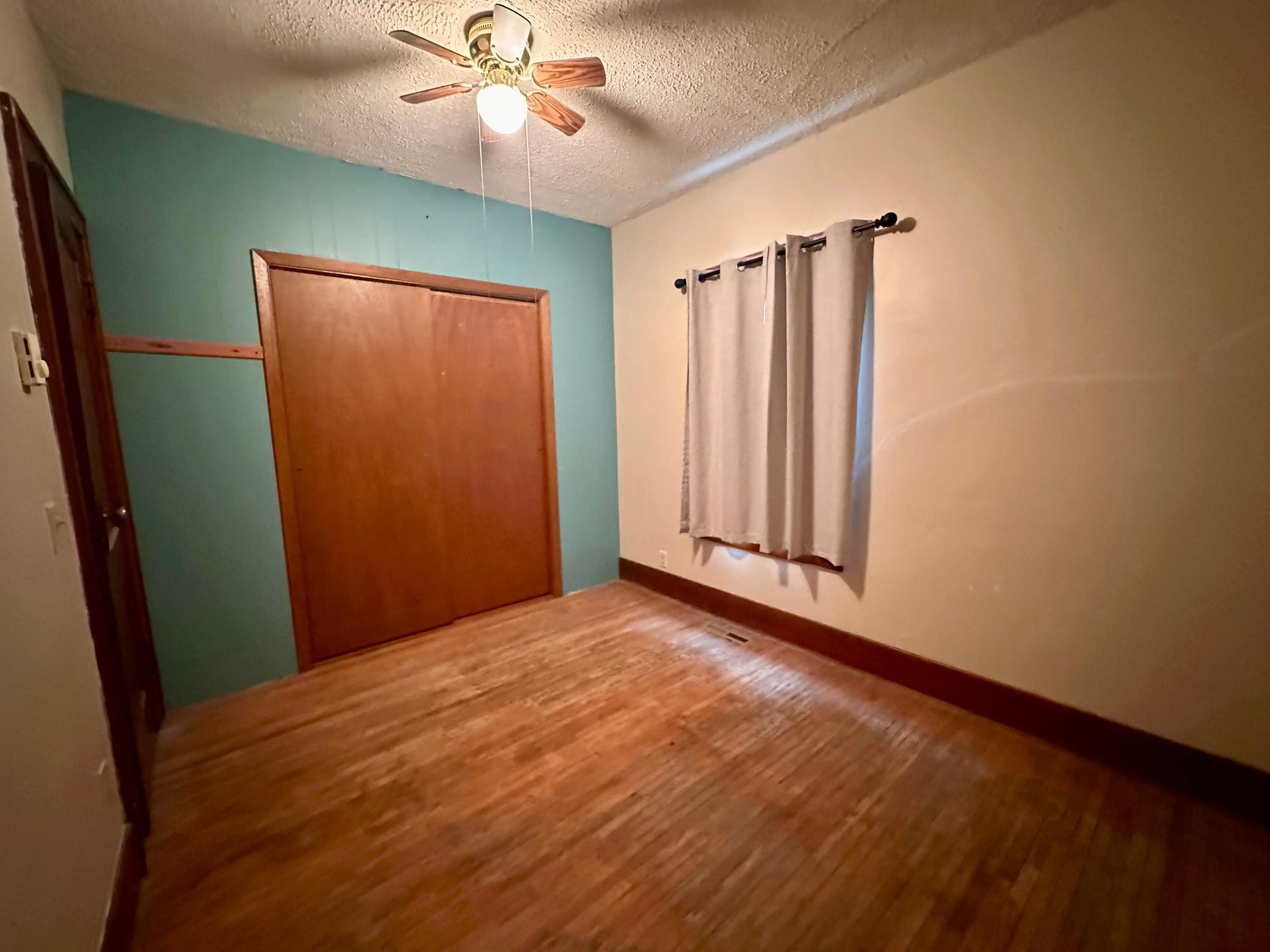 Bedroom 1 on Main Floor with closet and ceiling fan...