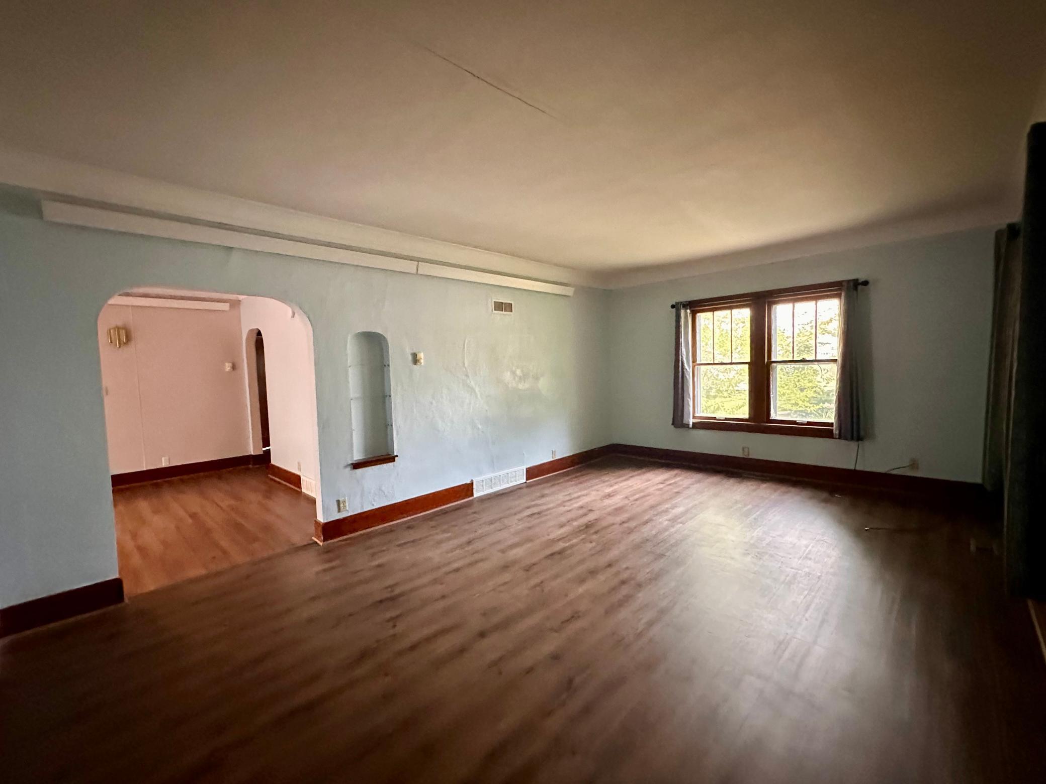 Open your front door into the LARGE living room space featuring brand new flooring (Installed July 2026)