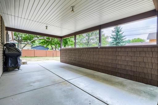 Note just a carport, a great area for outdoor use with its side wall and roof.