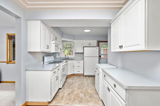 Bright and functional kitchen featuring crisp white cabinetry, abundant storage and counter space, with an open flow to the adjoining living areas.