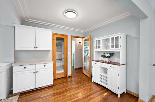 Convenient pantry and storage area just off the kitchen, offering additional cabinetry and storage while maintaining the home’s beautiful hardwood floors and classic charm.