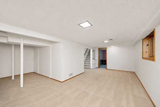 Spacious lower-level family room offers flexible space for a media area, game room, home gym or additional gathering space.