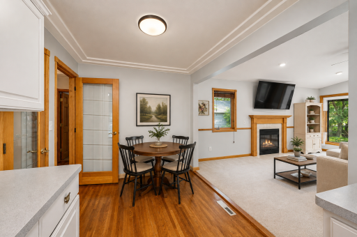 Virtually staged to showcase the possibilities — a charming dining area with beautiful hardwood floors and an open connection to the inviting family room and fireplace.