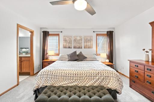 Upper level primary bedroom featuring a spacious walk-in closet and private bath