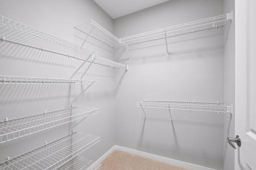 Generously sized walk-in closet located in the Primary Suite.
