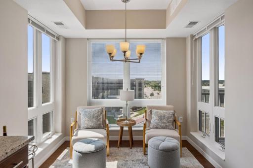 Nearly floor to ceiling windows in this adorable sunroom that could also be utlized as kitchen nook with dining table.