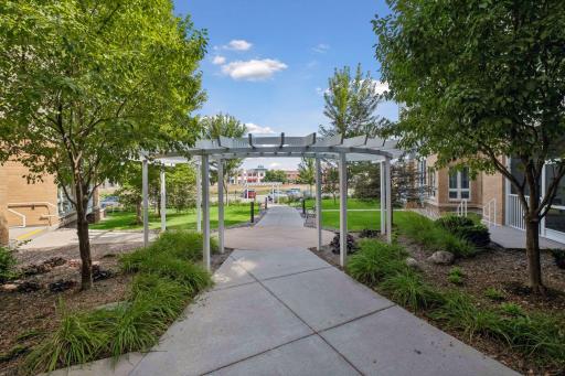 Beautiful trees & perennials adorn the front entrance of this vibrant 62+ community!