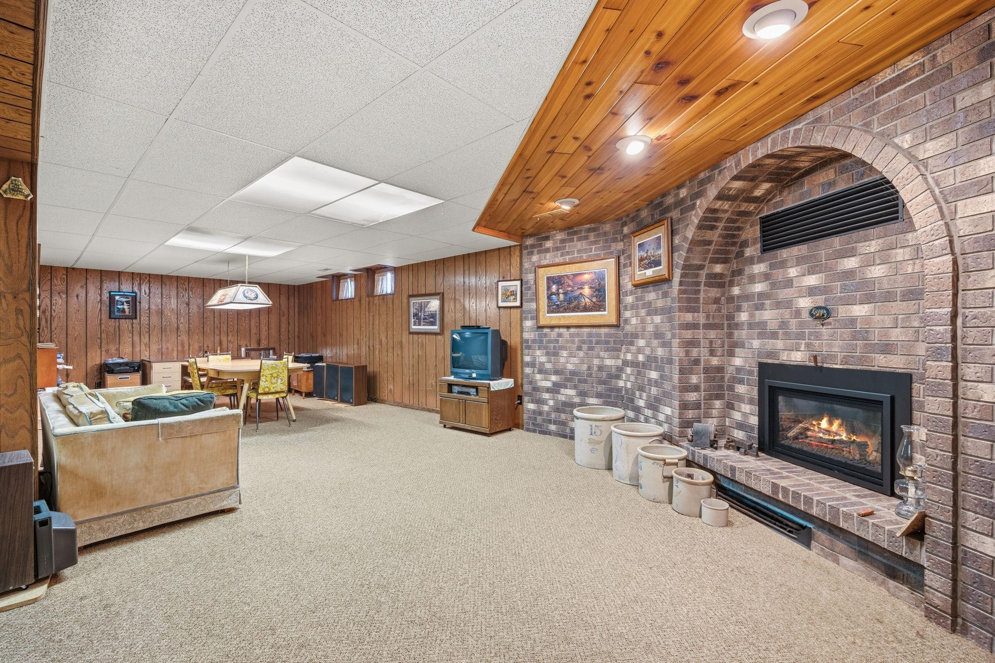 Lower level family room, brick surround fireplace