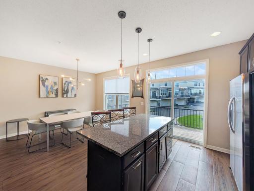 Glass doors lead to the deck above the garage!