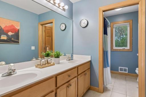 Double sinks and door to the toilet and shower area for more privacy