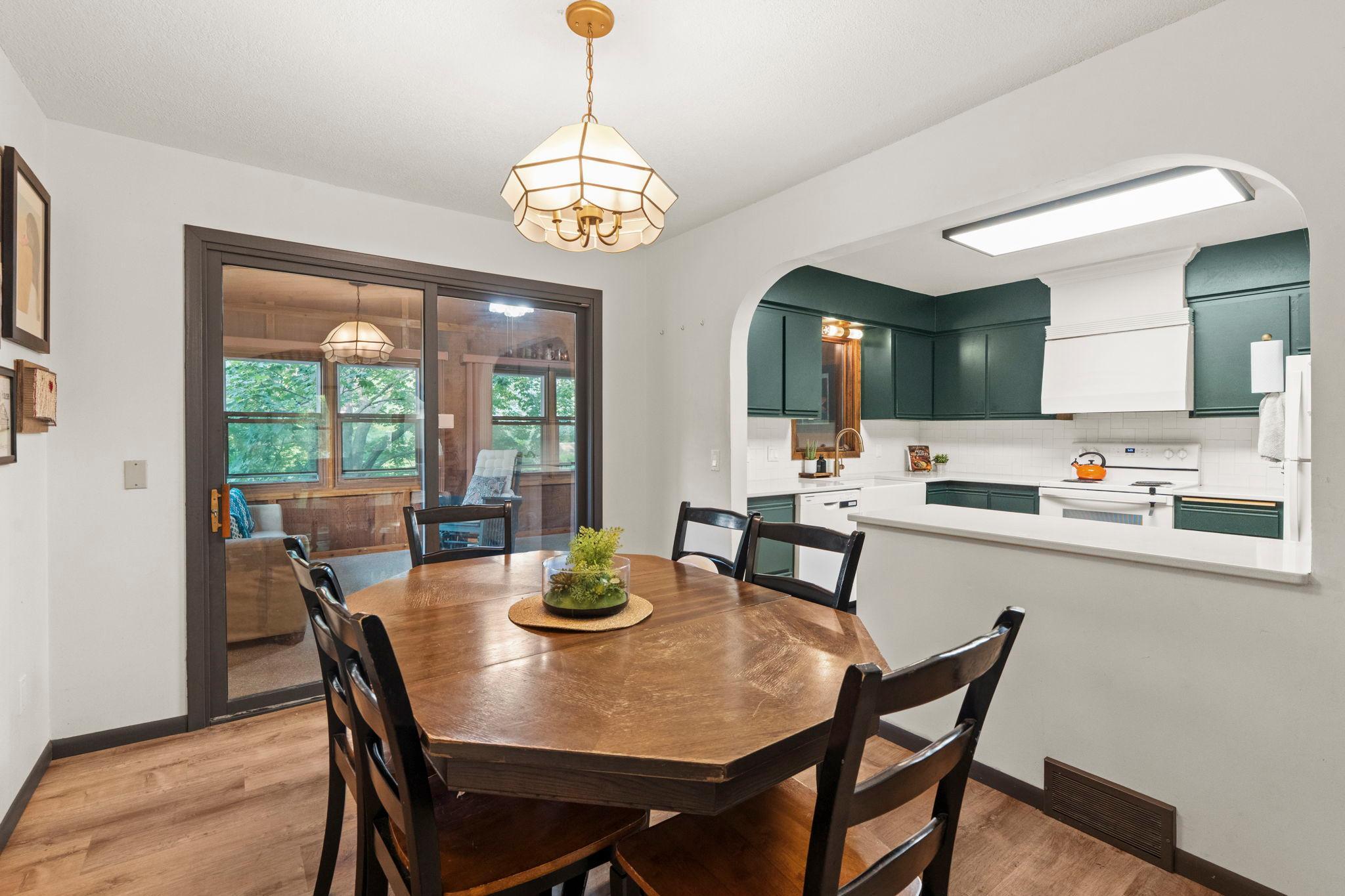 The kitchen is open to the dining area, sunroom and living space.