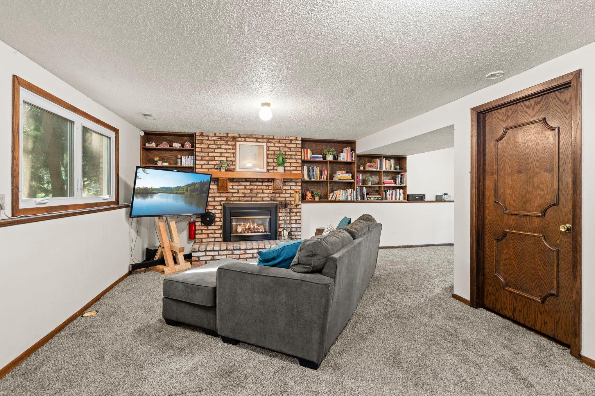 Lower level family room with gas fireplace for cozy winters