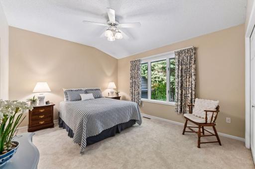 Spacious main-level primary bedroom with peaceful views and private bath.