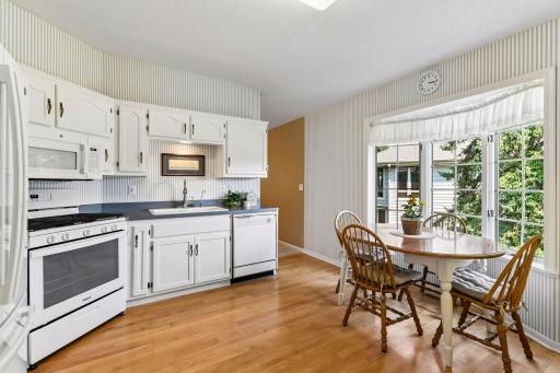 Window-filled dining area brings in natural light and views of the surrounding greenery.