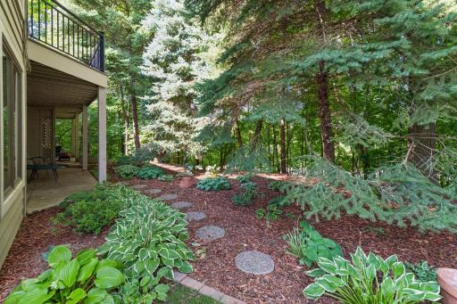 Large patio and beautifully shaded garden setting create a private place to relax outdoors.