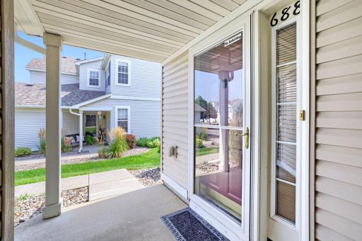 A cute covered front porch has space for a chair, table, or plants.