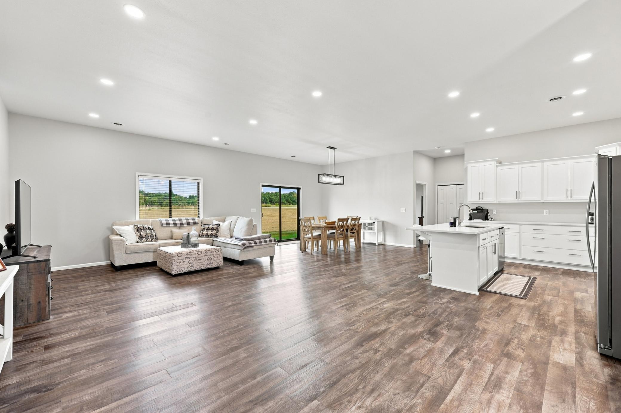 Large open area with LVP flooring throughout and lots of recessed lighting!