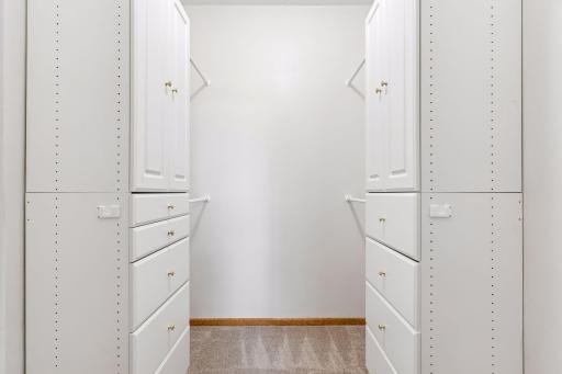 Expansive walk-in closet (6'8" x 5'11") outfitted with custom built-in cabinetry, organizers, and integrated drawer systems.