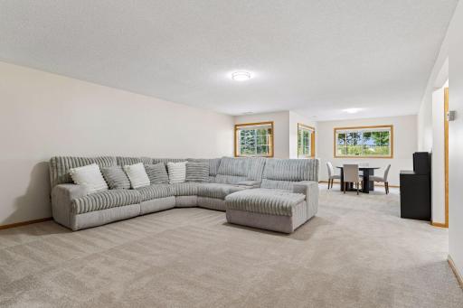 Massive finished lower-level family room featuring expansive space for entertaining, daylight windows, and a dedicated game or dining nook.