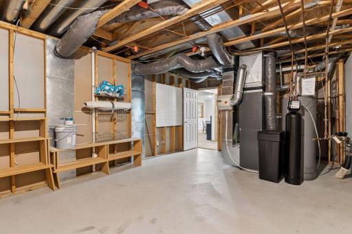 Spacious mechanical room featuring major mechanical upgrades including a high-efficiency furnace, updated water heater & water softener (2025), and updated electrical (2025).