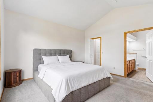 Primary suite view highlighting dual direct access to both the private ensuite bath and the custom walk-in closet.