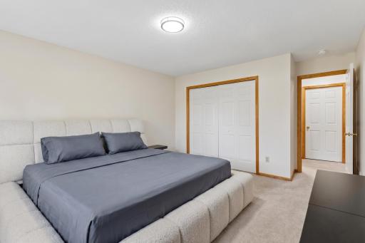 Lower-level bedroom featuring full double-door closet storage and easy proximity to the basement full bathroom.