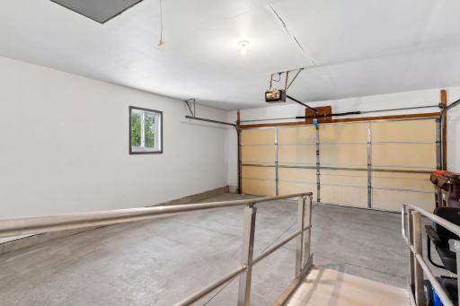 Spacious 2-car attached garage (20' x 22') featuring an automatic opener, ample storage space, and a built-in accessibility wheelchair ramp leading directly into the home.